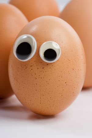 A group of eggs with eyes looking aroundの写真素材