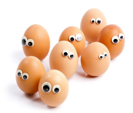 A group of eggs with eyes looking aroundの写真素材