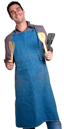 Man with an apron and cooking tools against a white backgroundの写真素材