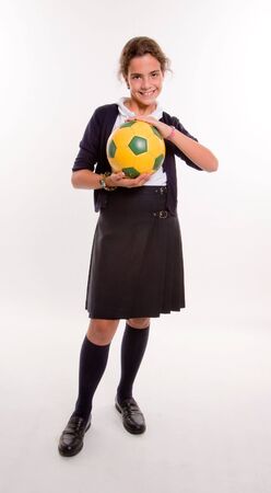 Schoolgirl in uniform with a soccer ballの写真素材