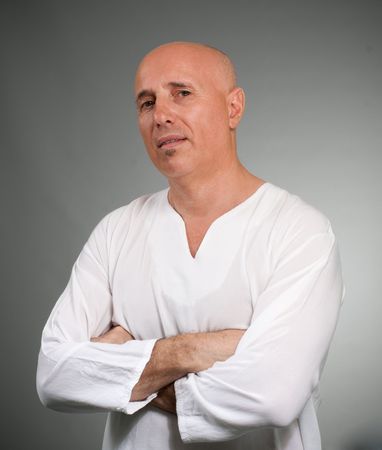 Bald mature man looking at the camera with a challenging stareの写真素材