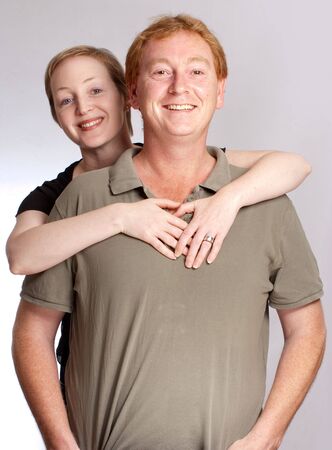 Smiling couple against a a white backgroundの写真素材