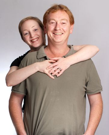 Smiling couple against a a white backgroundの写真素材
