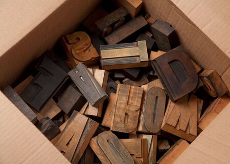 Cardboard box with lots of wooden typescript letter