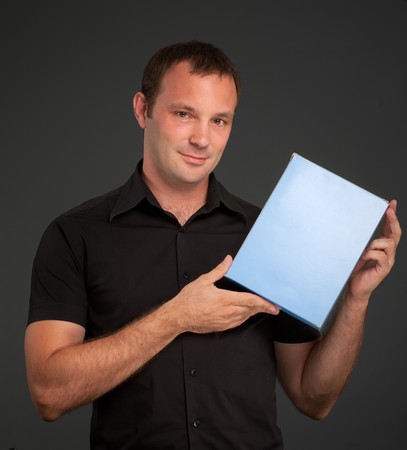 
Man in black holding a blank box
の写真素材