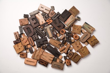 Wooden typescript letters against a white backgroundの写真素材