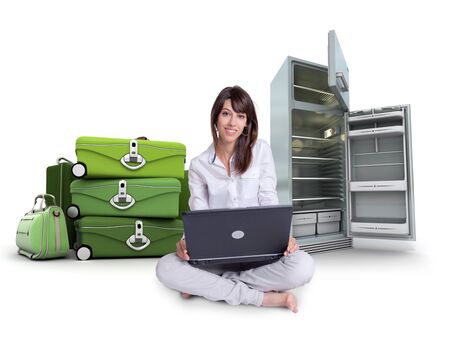 
Young woman using a laptop with a pile of suitcases and an empty fridge on the background

の写真素材