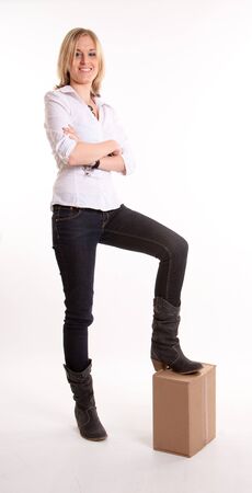 
Young woman with her foot on a cardboard box
の写真素材