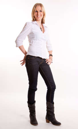 
Young blond woman in jeans and boots laughing against a white background
の写真素材