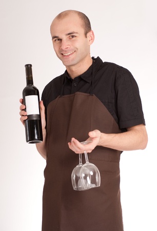 
Man with apron presenting a wine bottle with a blank lable
の写真素材