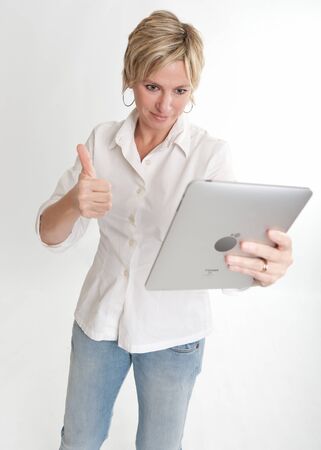 
Woman using a PC tablet doing the OK sign with her hand

の写真素材