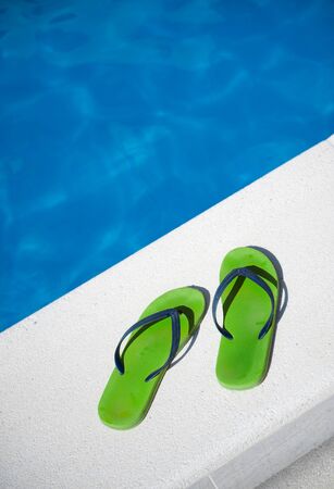 

A pair of green and blue sandals by a swimming pool

の写真素材