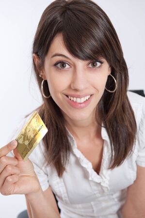 

Happy young woman holding a golden credit card

の写真素材