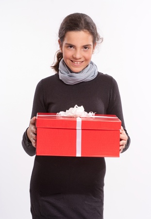 
Young girl holding a red gift box with a white bow
の写真素材