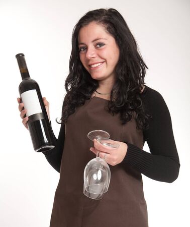 
Female with apron presenting a wine bottle with a blank label and a pair of glasses
の写真素材