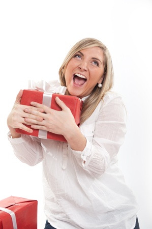 Happy blonde young woman holding a presentの写真素材