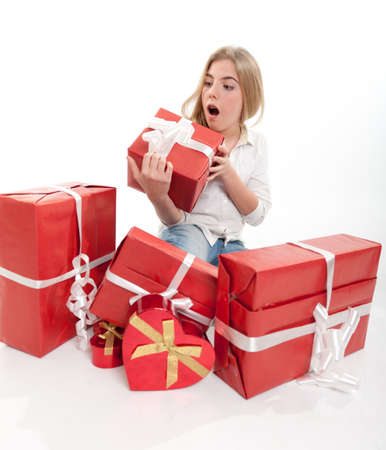 Young teenage girl happily with presentsの写真素材