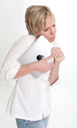 

Woman holding her Pc tablet like a baby
の写真素材