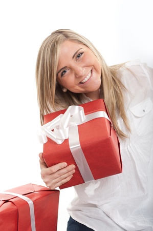 Laughing blonde young woman holding a presentの写真素材