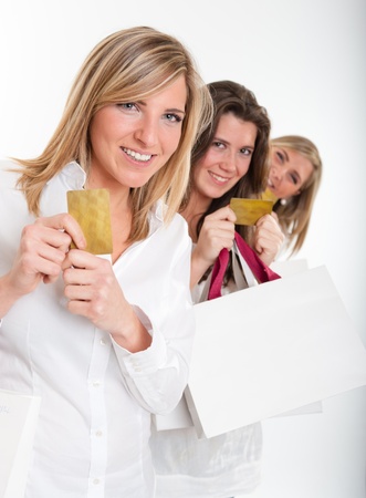 

Three young women with happy expressions with credit cards holding lots of shopping bags

の写真素材