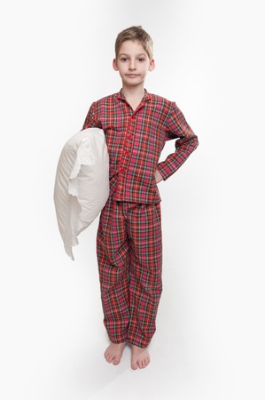 

Little boy in pyjamas holding a pillow 

の写真素材