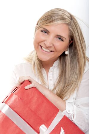 Laughing blonde young woman holding a presentの写真素材