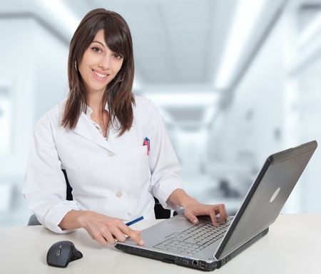 Young female hospital administrative in a desk at the hospital hallの写真素材