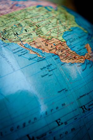 Close up shot on a vintage world globe focused on Mexico