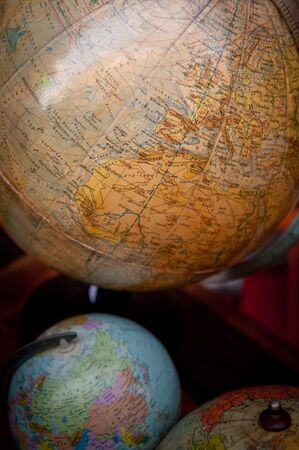 Shot of a collection of vintage desktop globesの写真素材