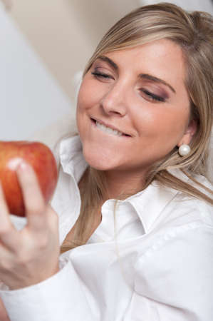 
A woman looking longingly to an apple
の写真素材