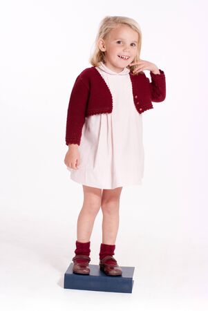 
Smiling little blonde girl standing on a book
の写真素材
