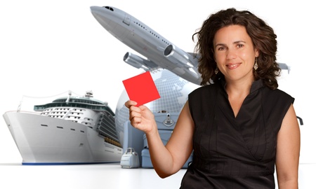 Smiling woman holding a blank red sign with an international travelling backgroundの写真素材