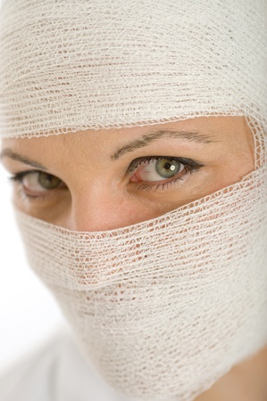 
Close-up portrait of a woman with a bandaged head and face

の写真素材
