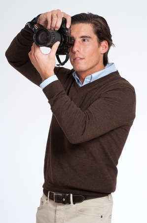 Man in brown taking a picture with a photo camera の写真素材
