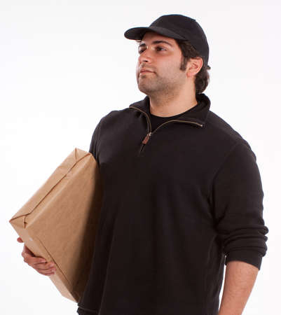 Portrait of a young man carrying a cardboard boxの写真素材