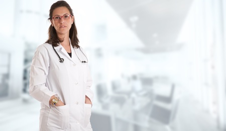 Woman with lab coat and stethoscope  in a business environmentの写真素材
