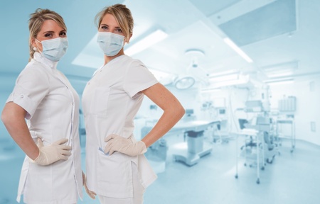 Two attractive healthcare professionals posing in an operating roomの写真素材