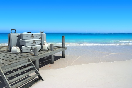 A pile of luxurious luggage standing by the pier on a tropical landscapeの写真素材