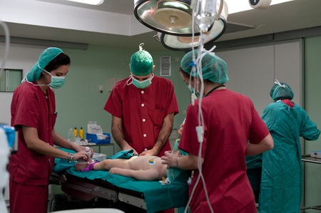 Medical team performing a pediatric surgeryのeditorial素材