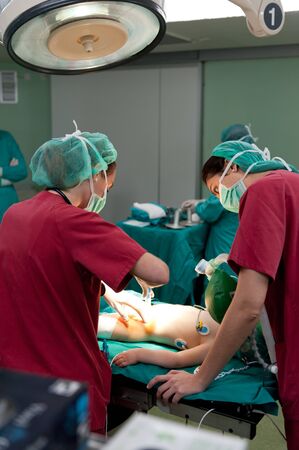 Medical team performing surgery on a young patientの写真素材