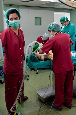 Medical team performing surgery on a young patientの写真素材
