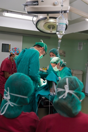 Medical team performing surgery on a young patientの写真素材