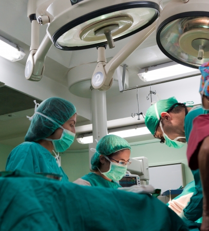 Medical team performing surgery on a young patientの写真素材