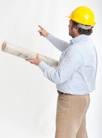 
Man with safety helmet looking at architecture blueprints pointing to the background
の写真素材
