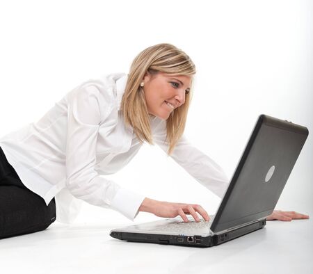 
Attractive happy young blonde using a laptop on the floor
の写真素材