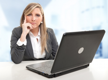 Serious business woman sitting at her desk with an attentive listener expressionの写真素材