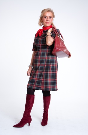 Full portrait of a mature woman in a tartan dressの写真素材