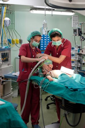Medical team performing surgery on a young patientの写真素材