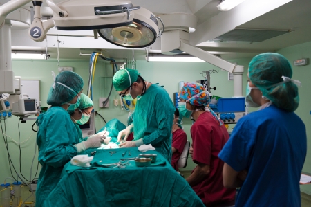 Medical team performing surgery on a young patientの写真素材