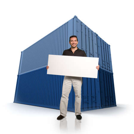 Smiling man holding a blank sign with blue cargo containers on the backgroundの写真素材